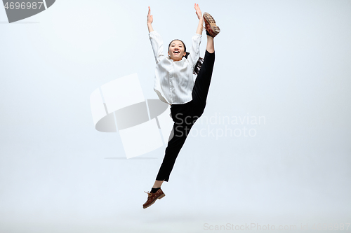 Image of Woman working at office and jumping isolated on studio background