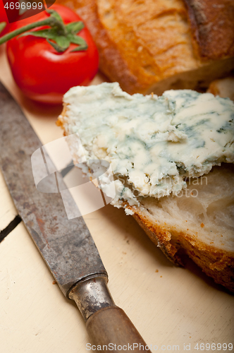 Image of fresh blue cheese spread ove french baguette