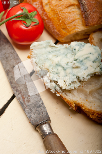 Image of fresh blue cheese spread ove french baguette