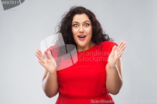 Image of happy surprised woman in red dress