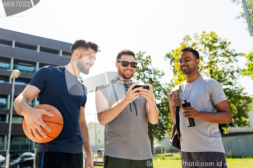 Image of men with smartphone at basketball playground