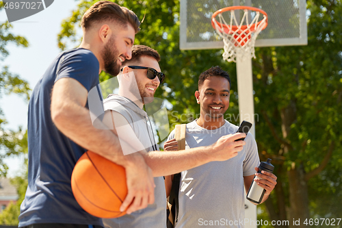 Image of men with smartphone on basketball playground