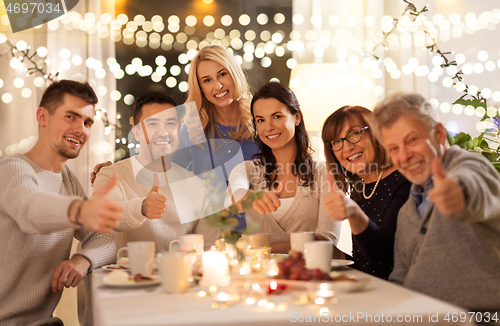 Image of happy family having tea party at home