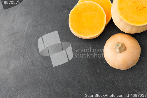 Image of cut pumpkin on stone background