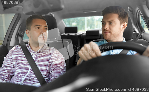 Image of car driving school instructor and male driver