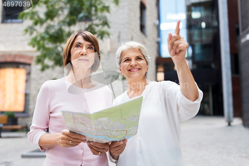 Image of senior women with city map on street in tallinn