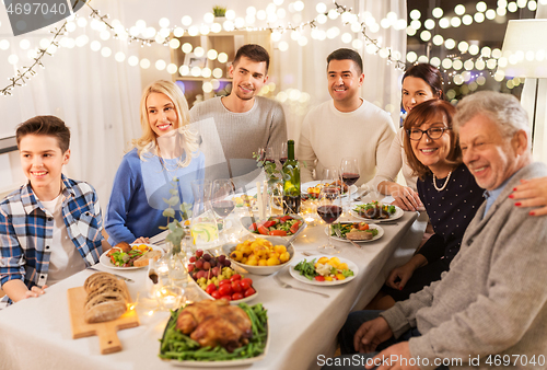 Image of happy family having dinner party at home