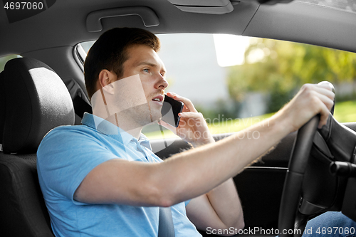 Image of man driving car and calling on smartphone