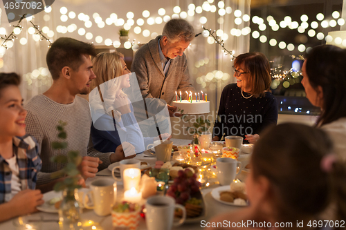 Image of happy family having birthday party at home