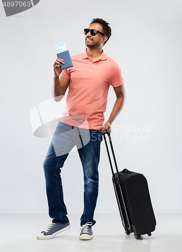 Image of indian man with travel bag passport and air ticket