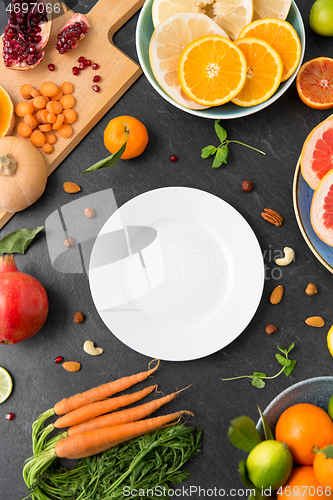 Image of plate, vegetables and fruits on on slate table