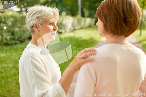 Image of senior women or friends talking at summer park