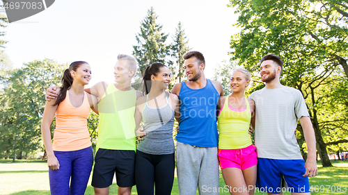 Image of group of happy friends or sportsmen at summer park