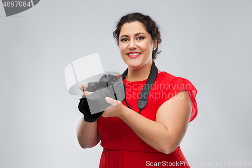 Image of happy woman photographer with digital camera