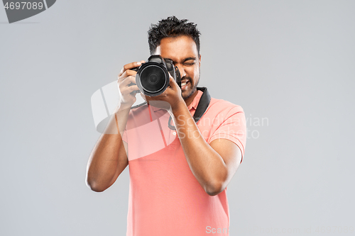 Image of indian man or photographer with digital camera