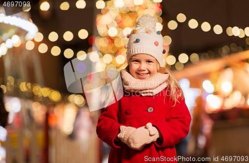 Image of happy little girl at christmas market in winter