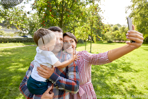 Image of happy family taking selfie at summer park