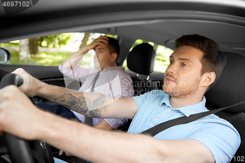 Image of car driving instructor talking to man failed exam