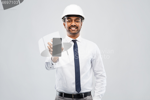 Image of indian male architect in helmet showing smartphone