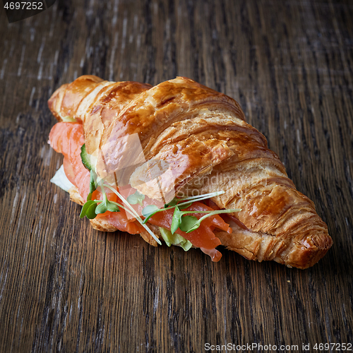 Image of Fresh croissant with salmon and greens