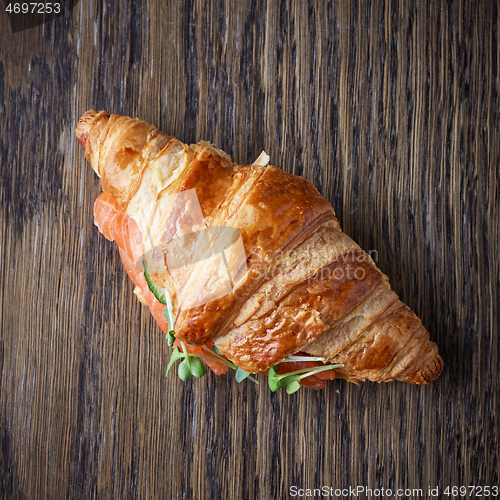 Image of Fresh croissant with salmon and greens