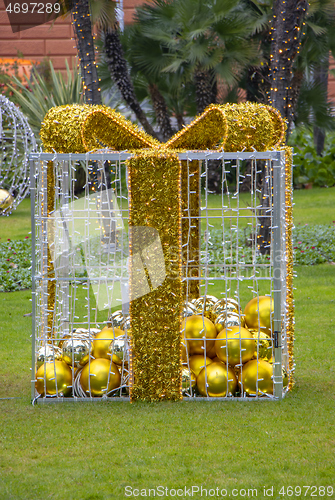 Image of Christmas gift boxes with ball in a city park