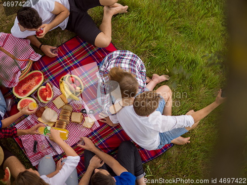 Image of top view of group friends enjoying picnic time