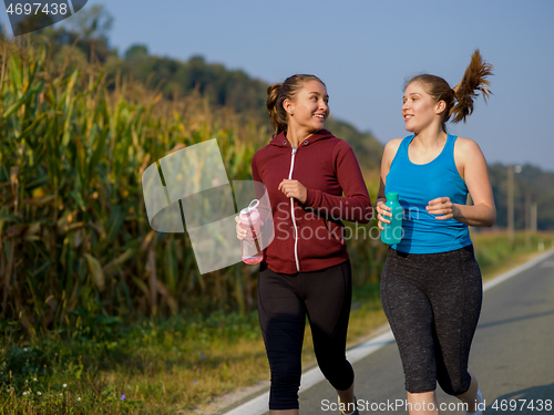 Image of women jogging along a country road