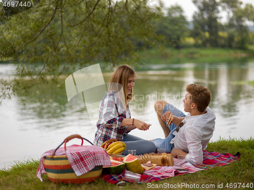 Image of Couple in love enjoying picnic time