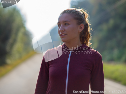 Image of woman jogging along a country road