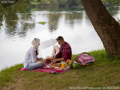 Image of Couple in love enjoying picnic time