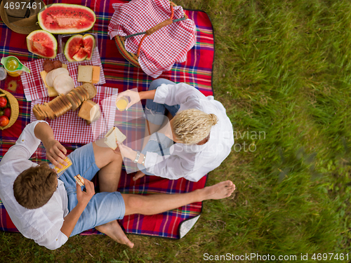 Image of top view of couple enjoying picnic time