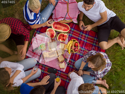 Image of top view of group friends enjoying picnic time