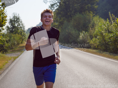 Image of man jogging along a country road