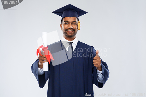 Image of male graduate student in mortar board with diploma