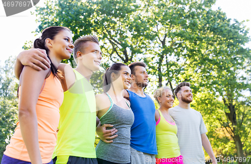 Image of group of happy friends or sportsmen at summer park