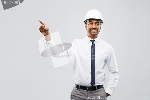 Image of indian male architect in helmet showing something