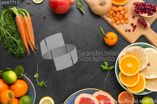 Image of different vegetables and fruits on on slate table