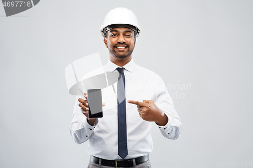 Image of indian male architect in helmet showing smartphone