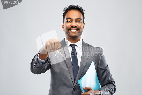 Image of indian man realtor with key and folder