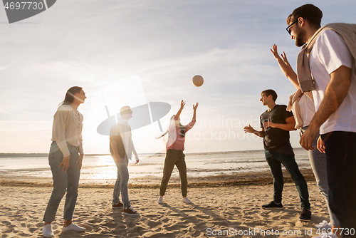 Image of friends playing volleyball on beach in summer