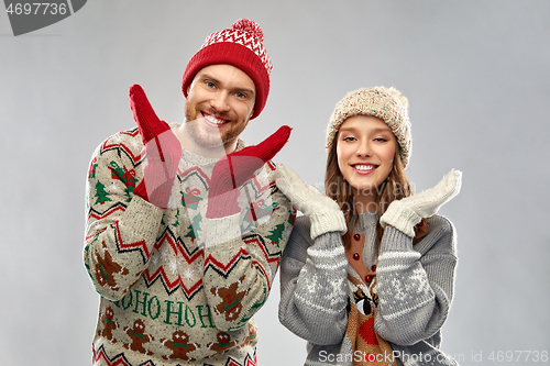 Image of happy couple at christmas ugly sweater party