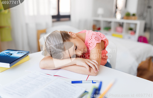 Image of tired student girl sleeping on table at home