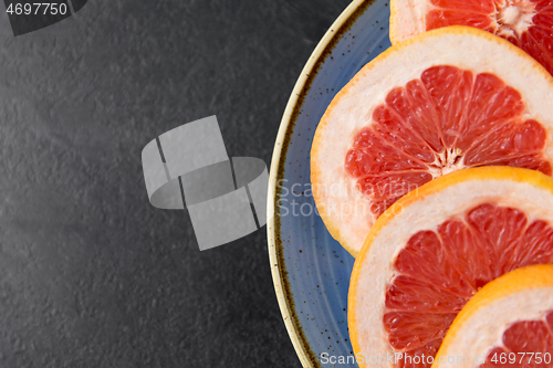 Image of close up of fresh juicy grapefruits on plate