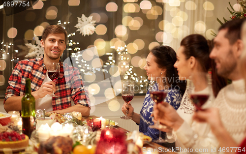 Image of friends celebrating christmas and speaking toast