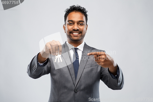 Image of indian man realtor with keys and folder