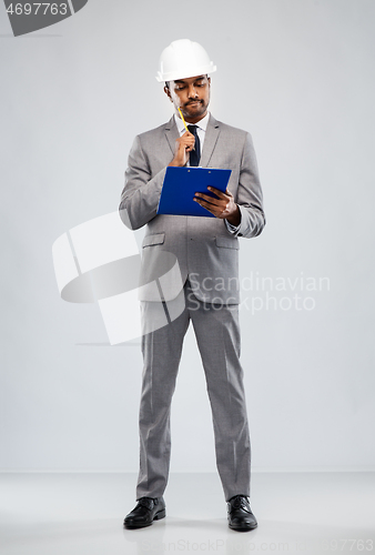 Image of indian male architect in helmet with clipboard