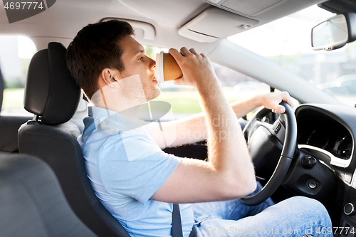 Image of man or driver driving car and drinking coffee