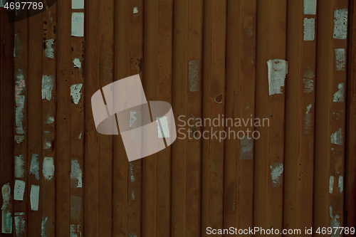 Image of Wooden wall or fence with poster remnants