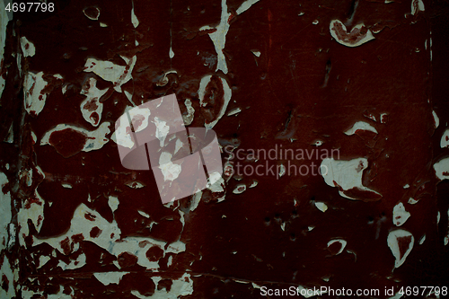 Image of Old wooden panel with grungy peeling dark paint